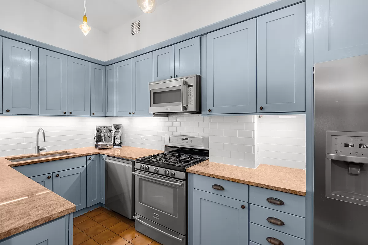 kitchen with blue cabinets and a dishwasher