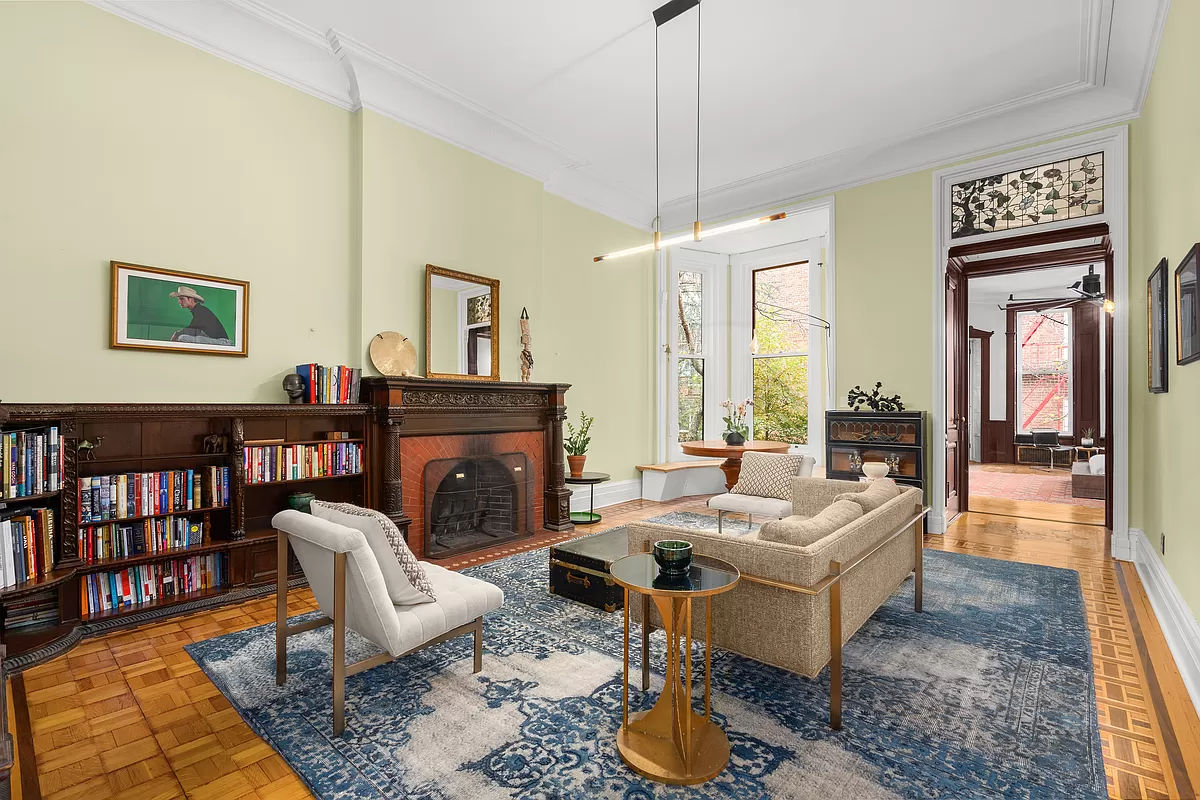 living room with wood mantel and bookshelves