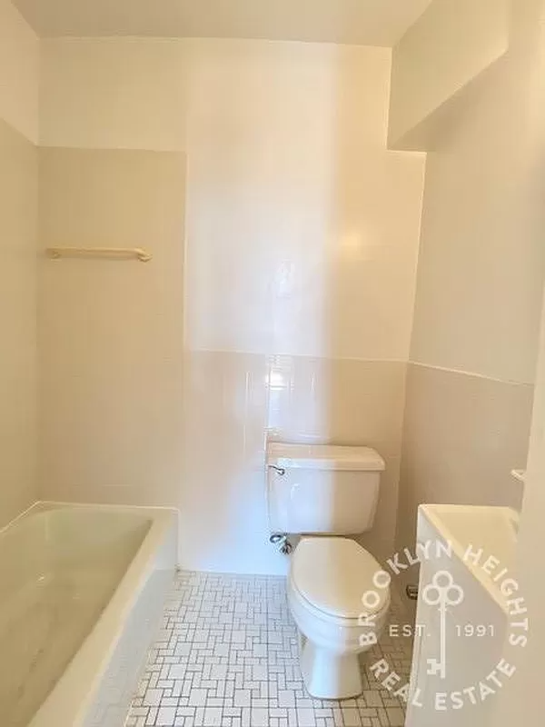 bathroom with beige wall and floor tile