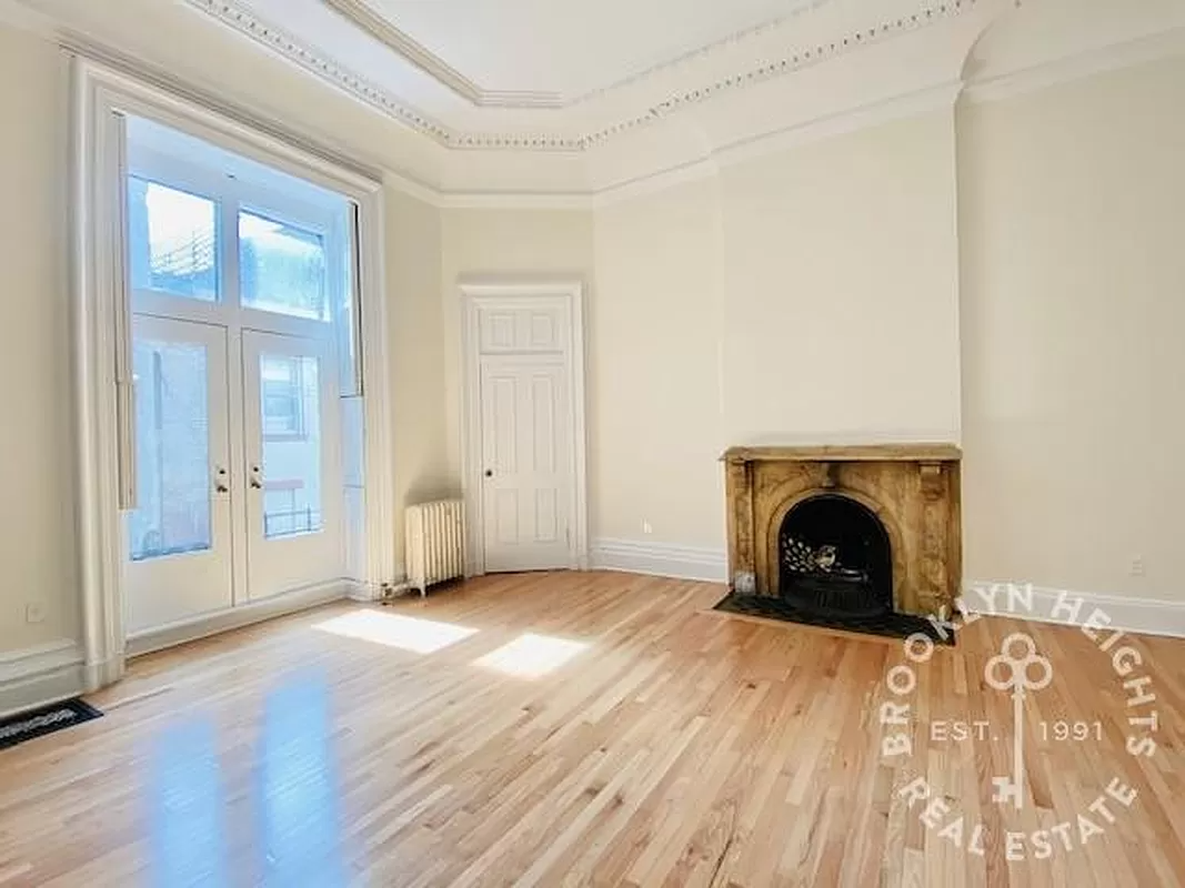 living room with mantel, french doors, plaster details