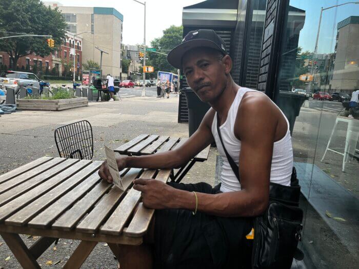 man sitting at a table outside