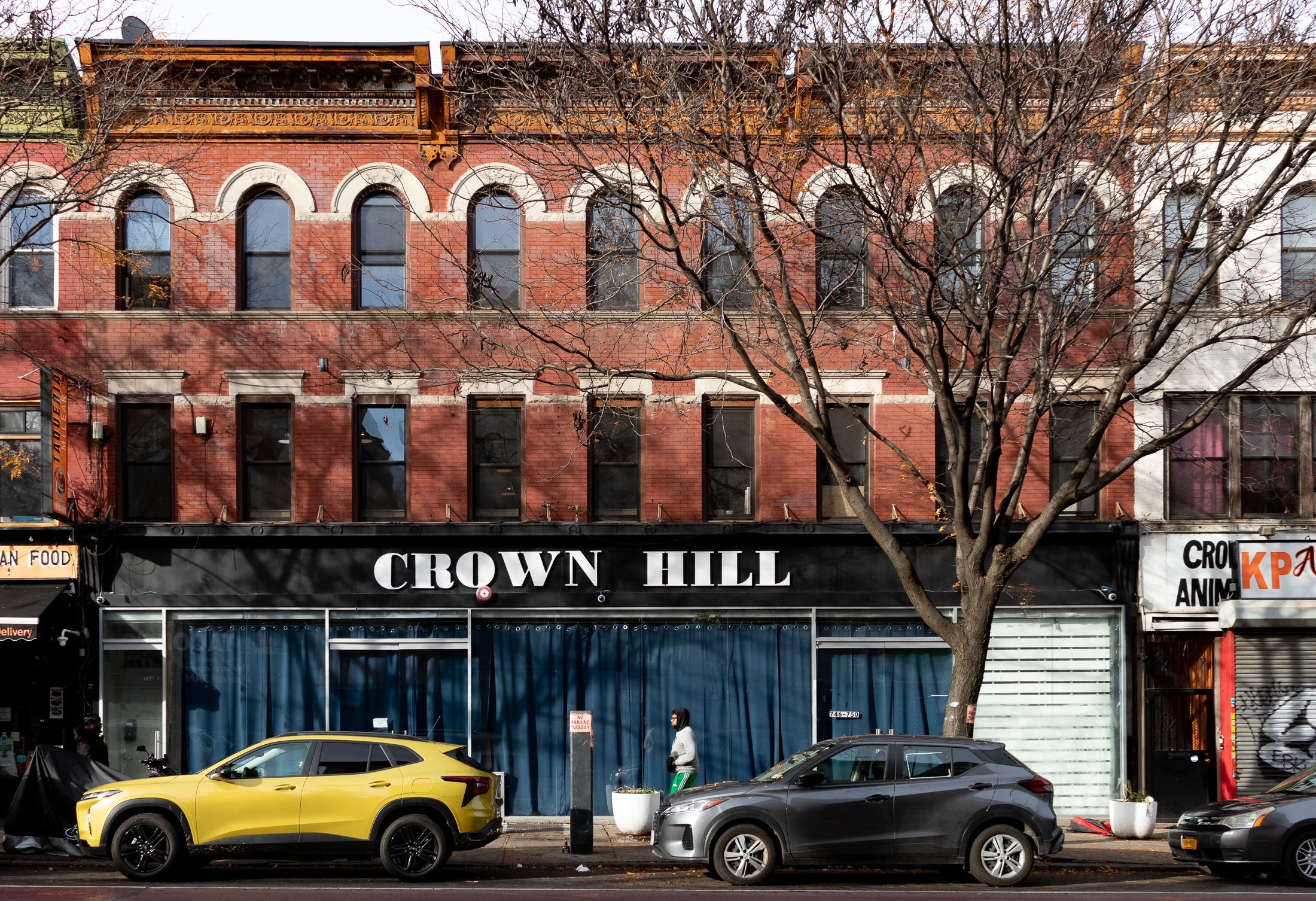brick exterior with a sign for Crown Hill