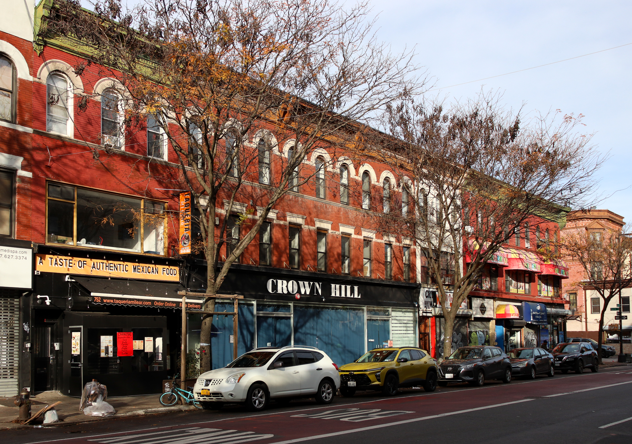 view along nostrand showing the brick buildng with crown hill sign