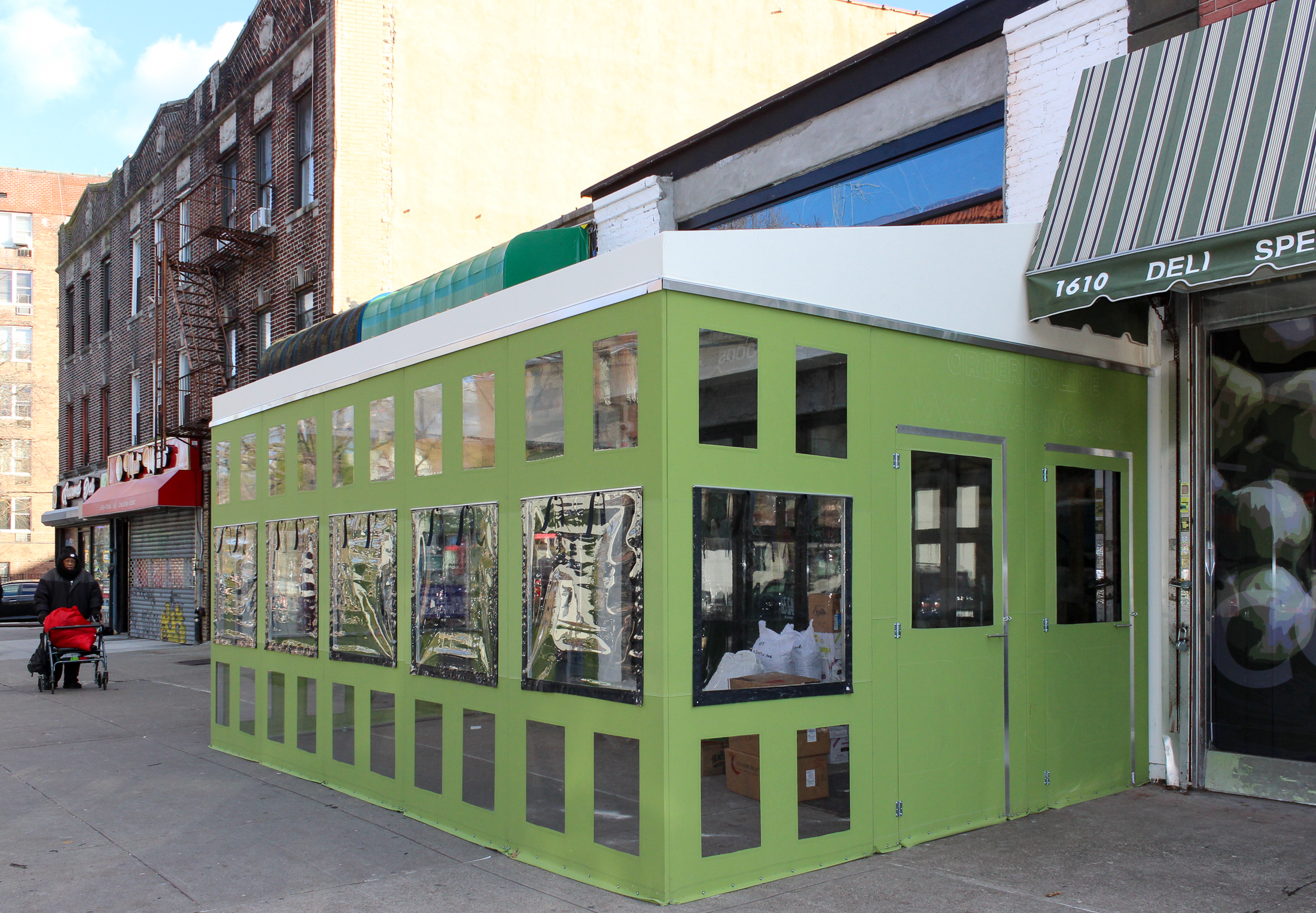 ayat restaurant - green weatherized enclosure around the new restaurant