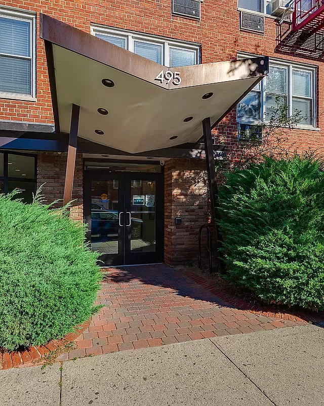 entrance to the building with a winged canopy