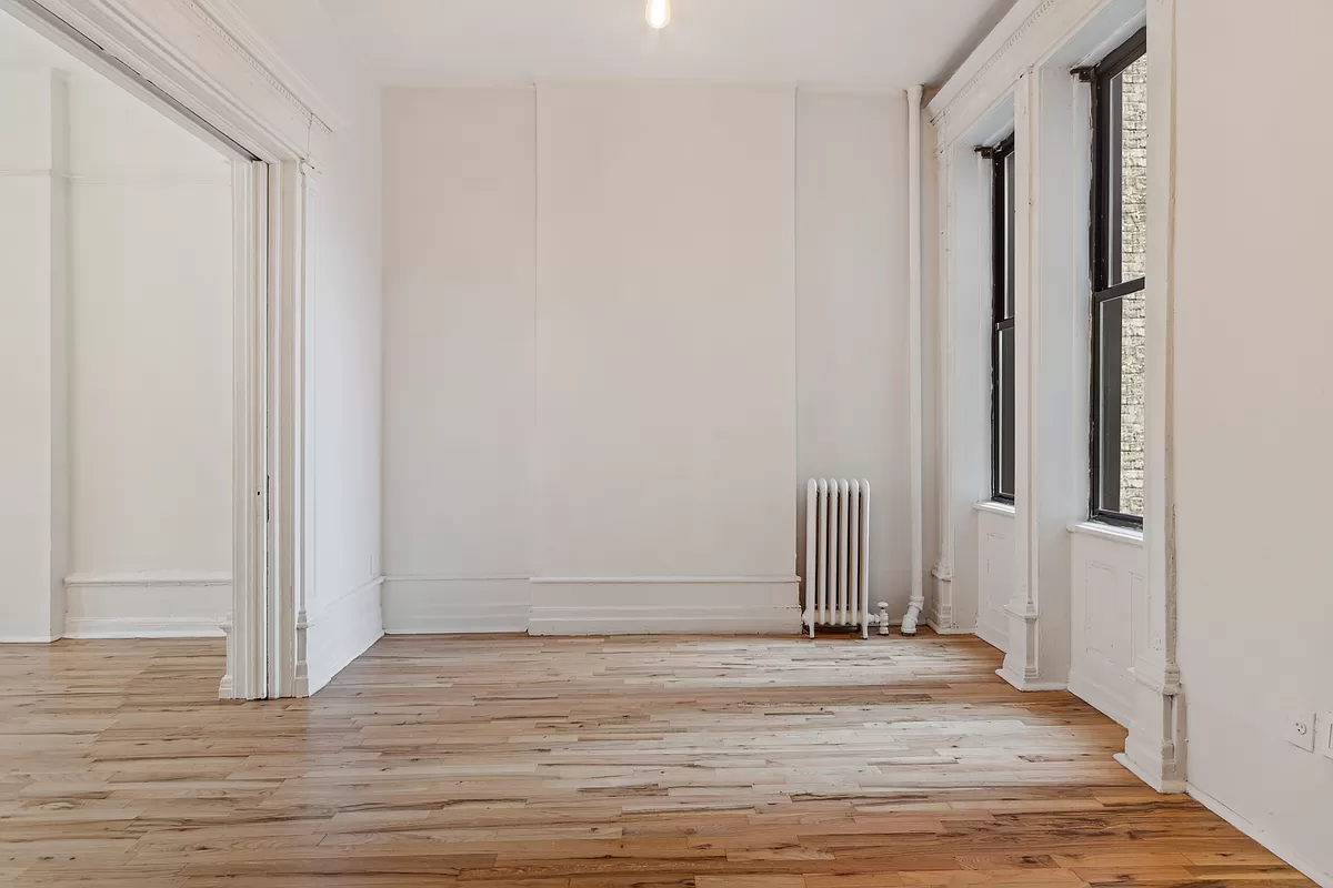 bedroom with wood floor and view to living room