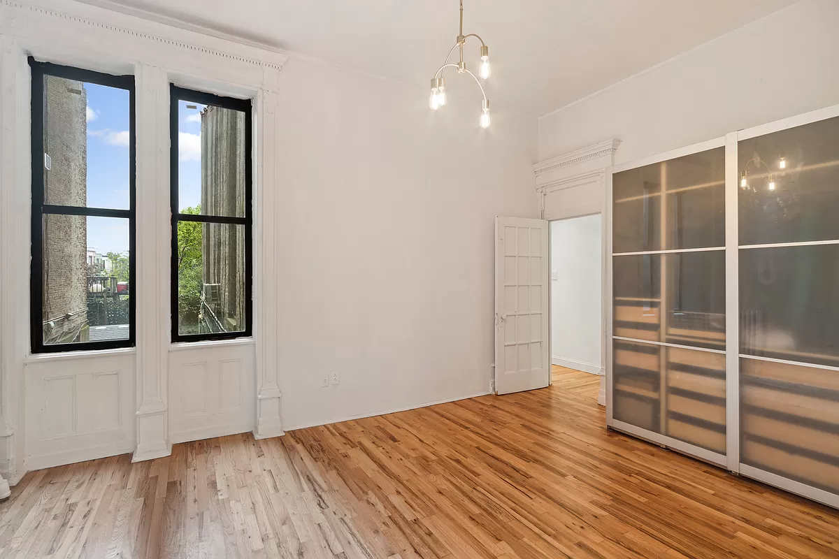 bedroom with two windows and wood floor