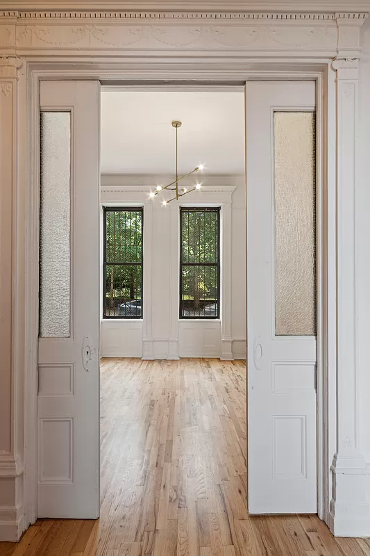 pocket doors with glass leading from living to bedroom