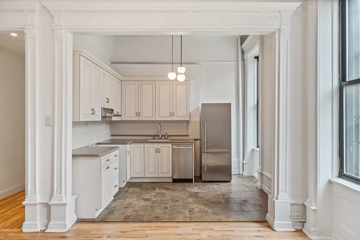 kitchen with cream cabinets and a narrow dishwasher