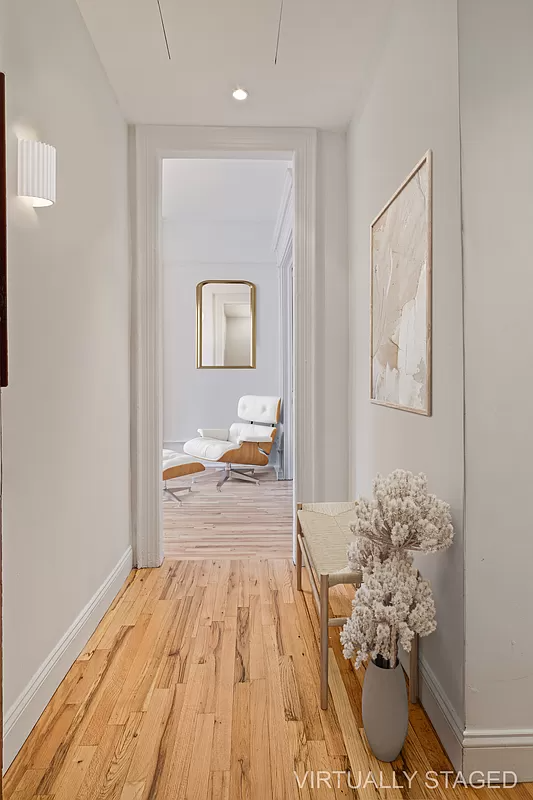 virtually staged foyer with a narrow bench