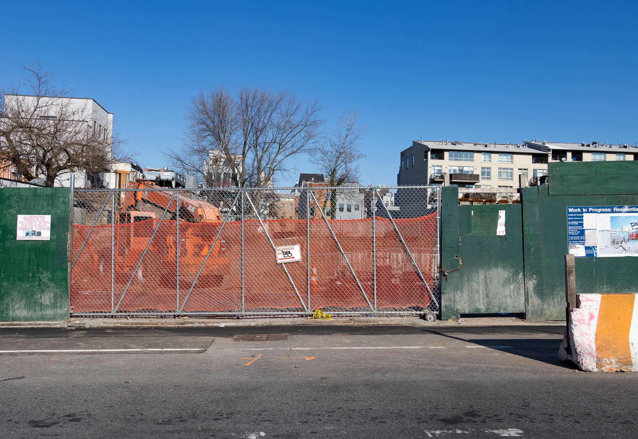 view of gate at construction site with equipment visible