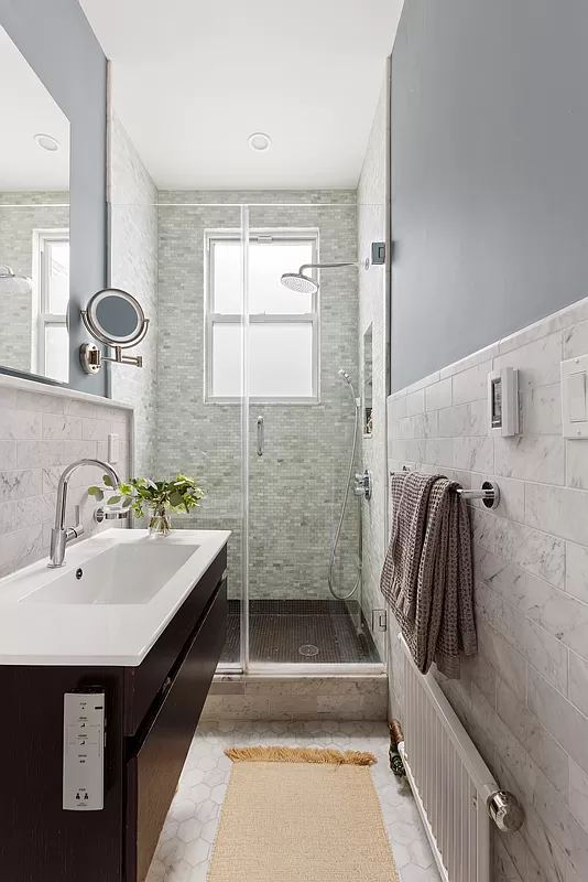 bathroom with a shower and a floating vanity