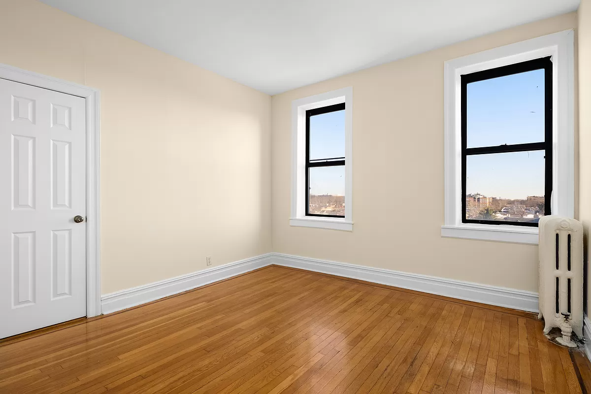 bedroom with two windows and wood floor