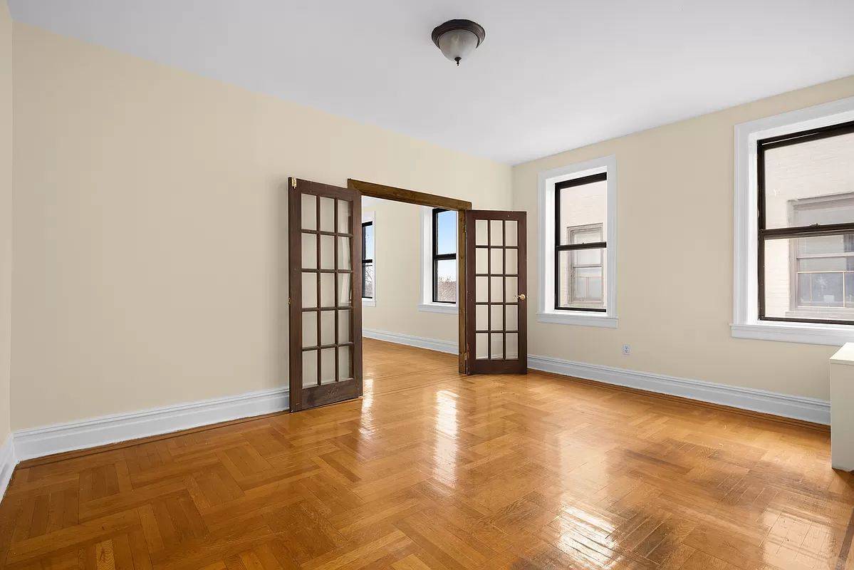 open french doors leading from dining room to the living room, both with wood floors