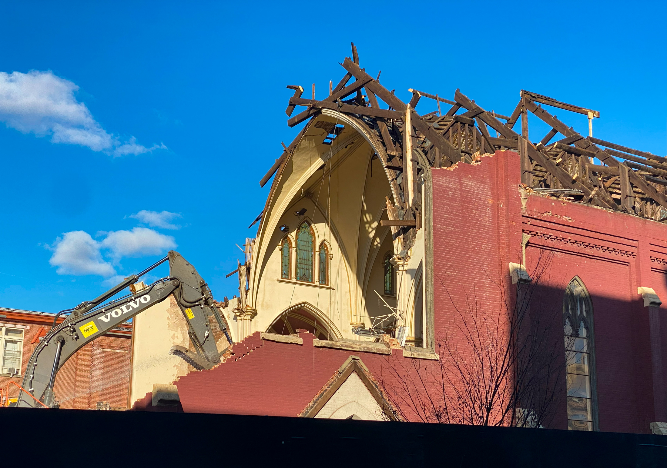 excavator digging into church