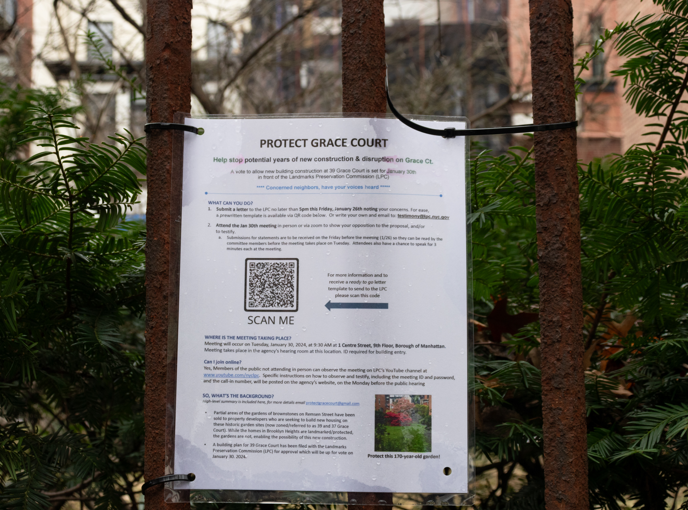 protest sing on the fence with information on how to attend meetings and register opinions