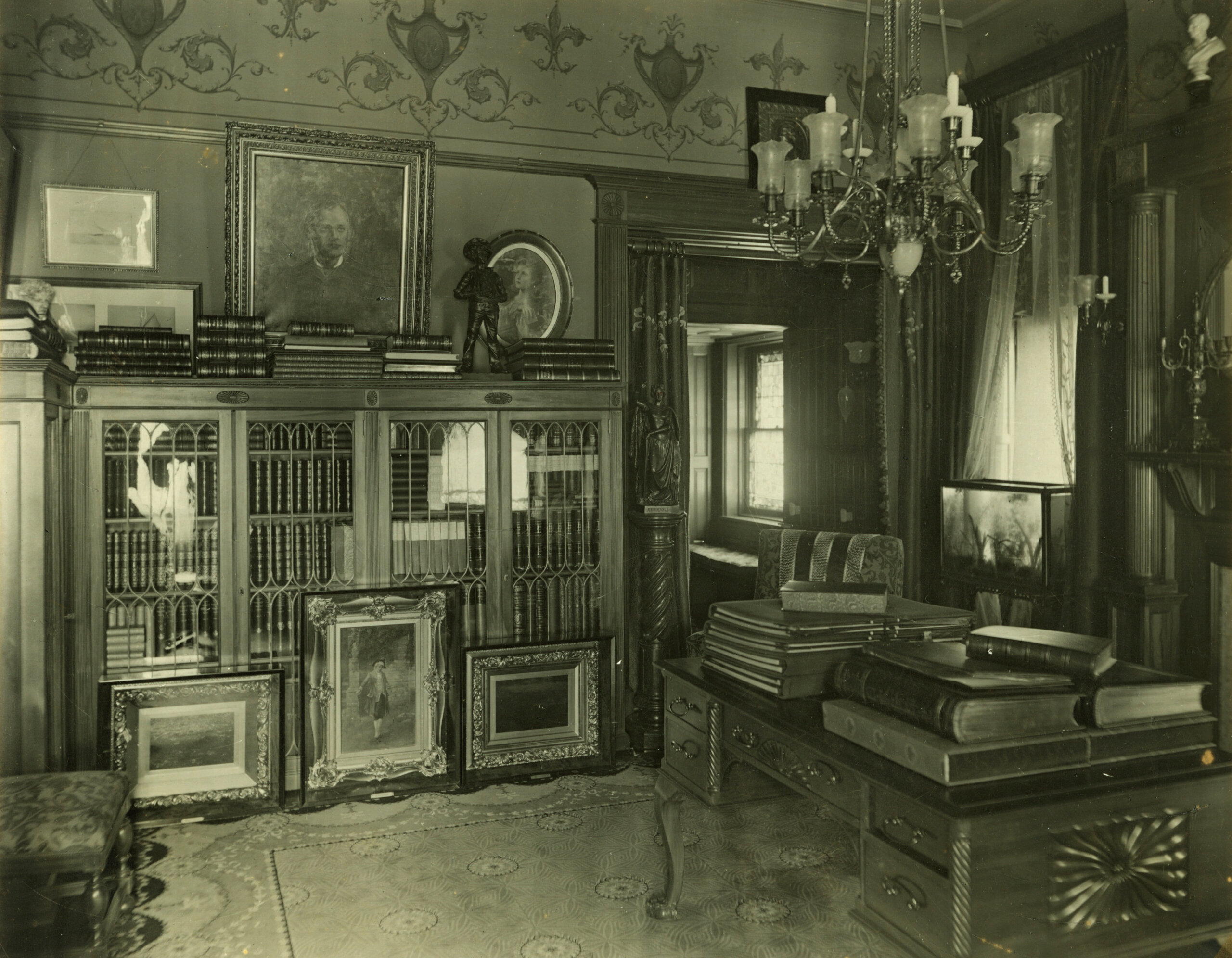 library with decorative painting and glass fronted bookcases