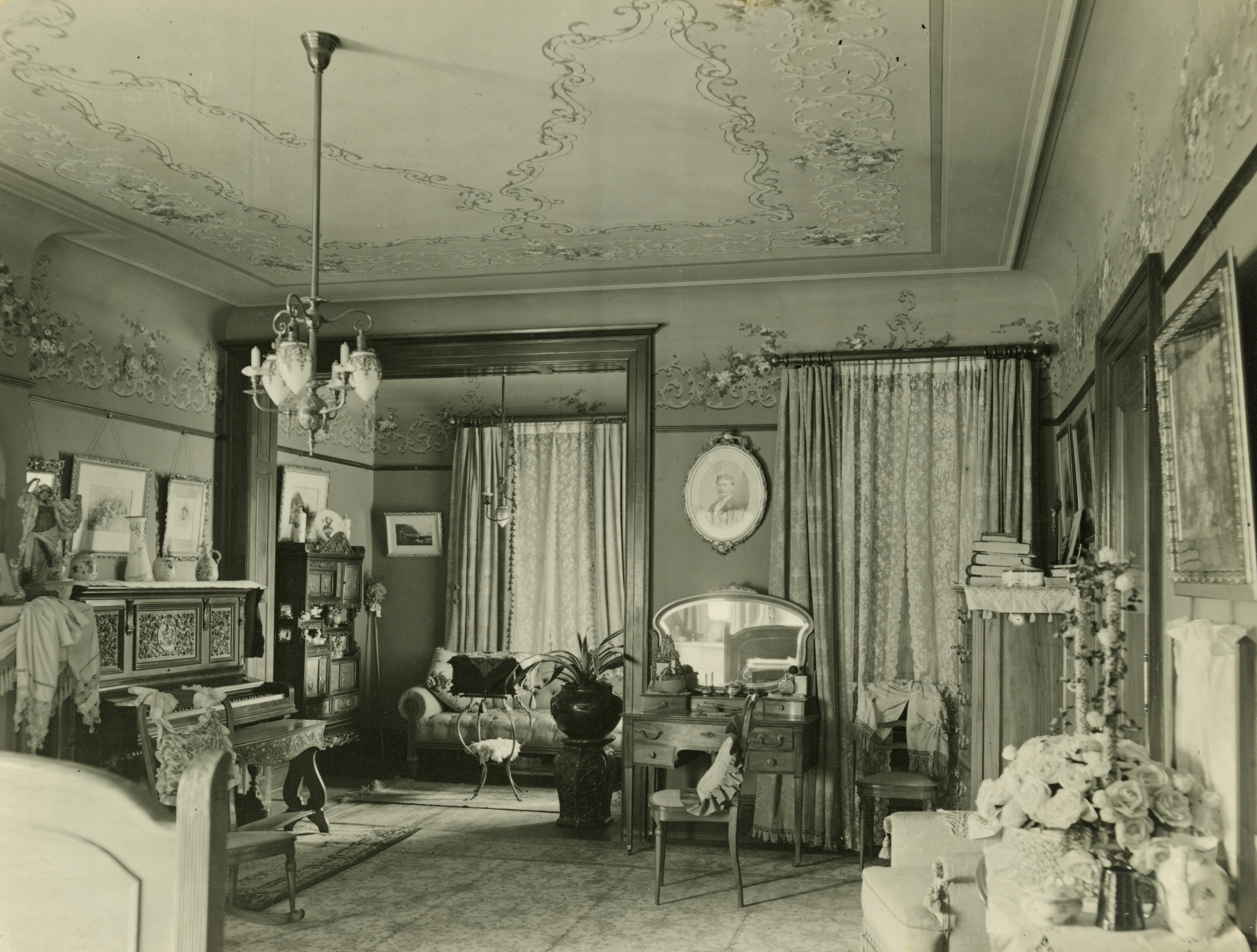 parlor with a piano and a niche with sofa