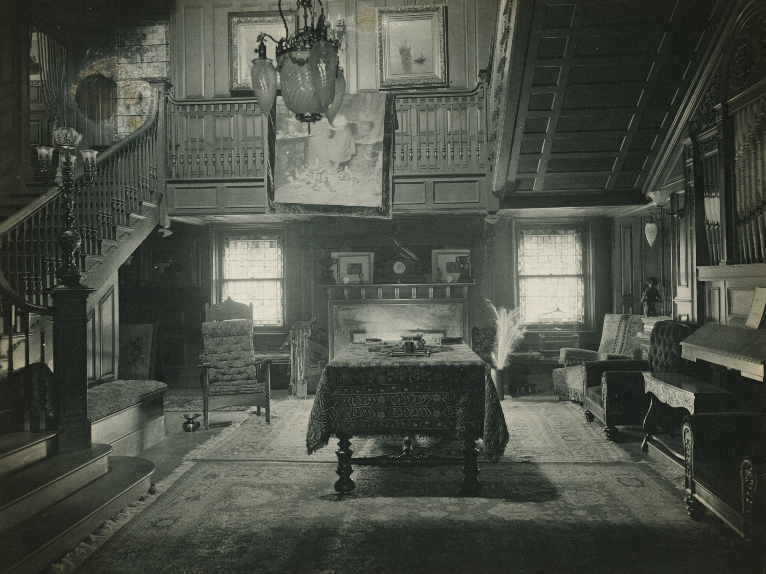 stair hall with central table and a mantel