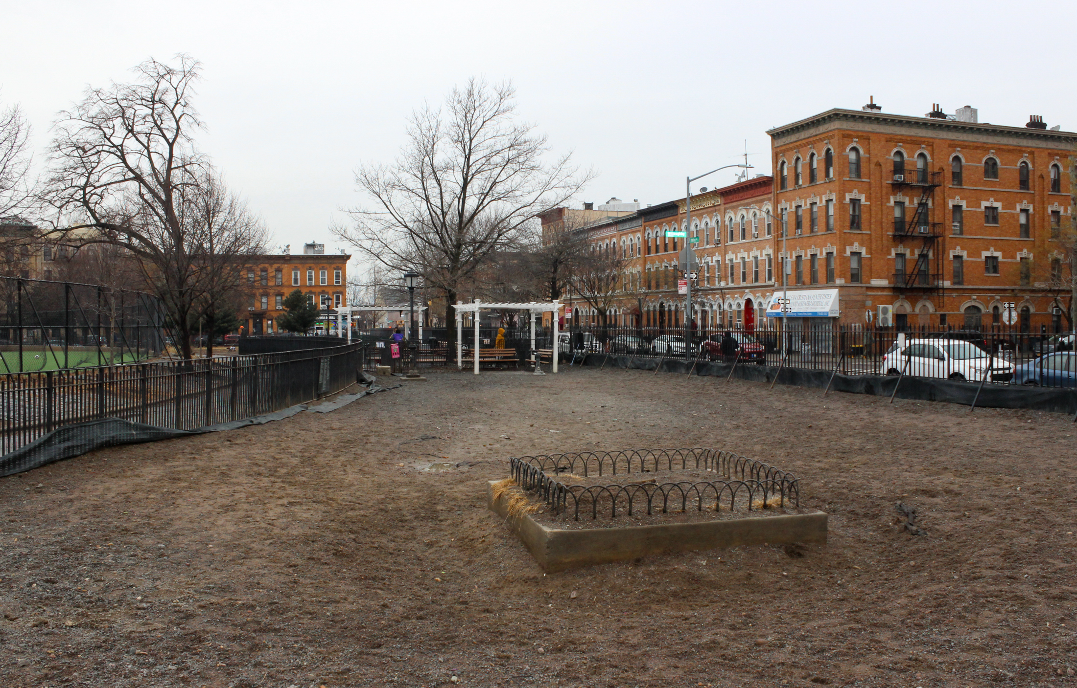 inside the dirt dog park with view of pergola