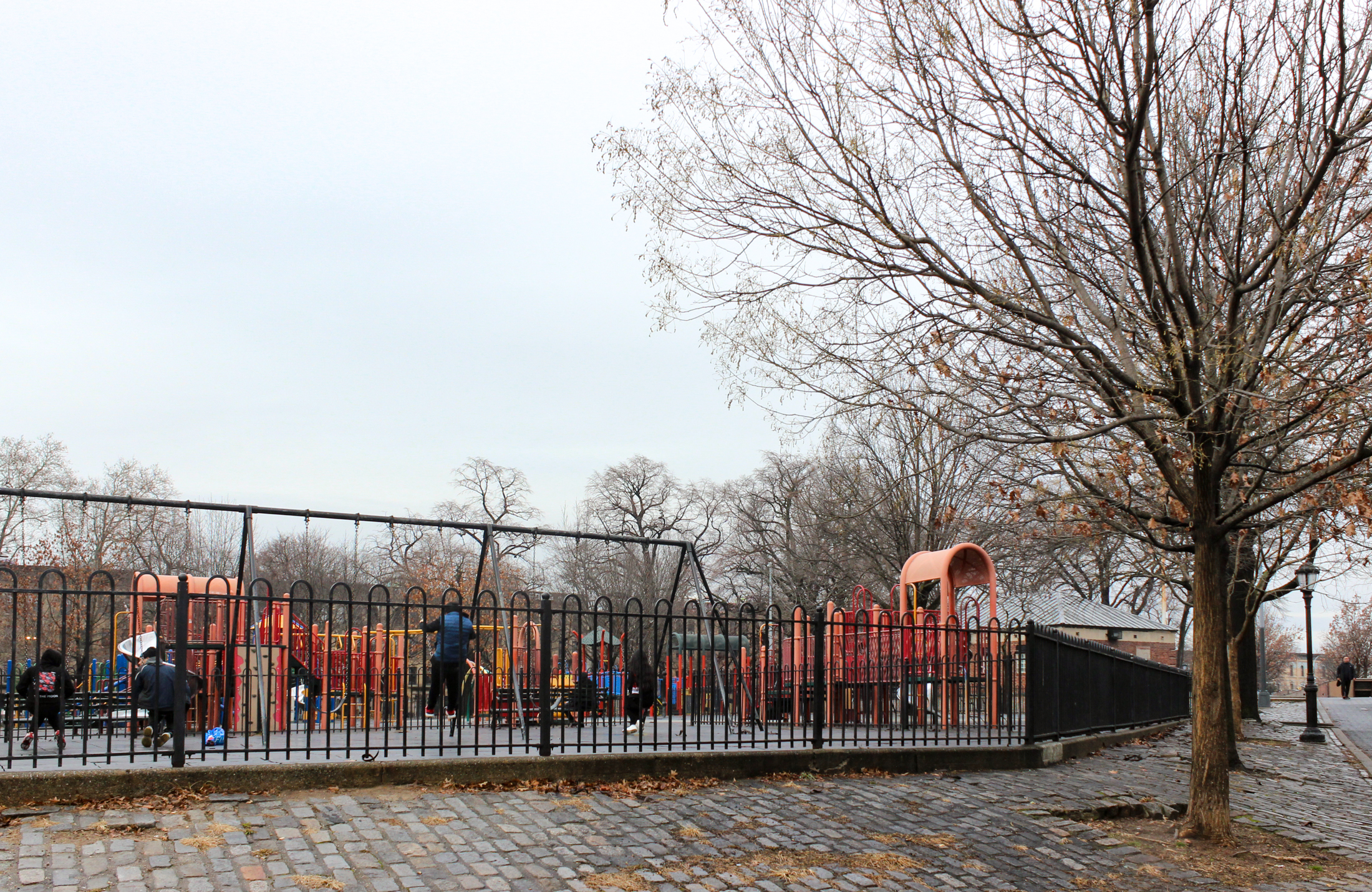 fence around the playground with glimpse of equipment