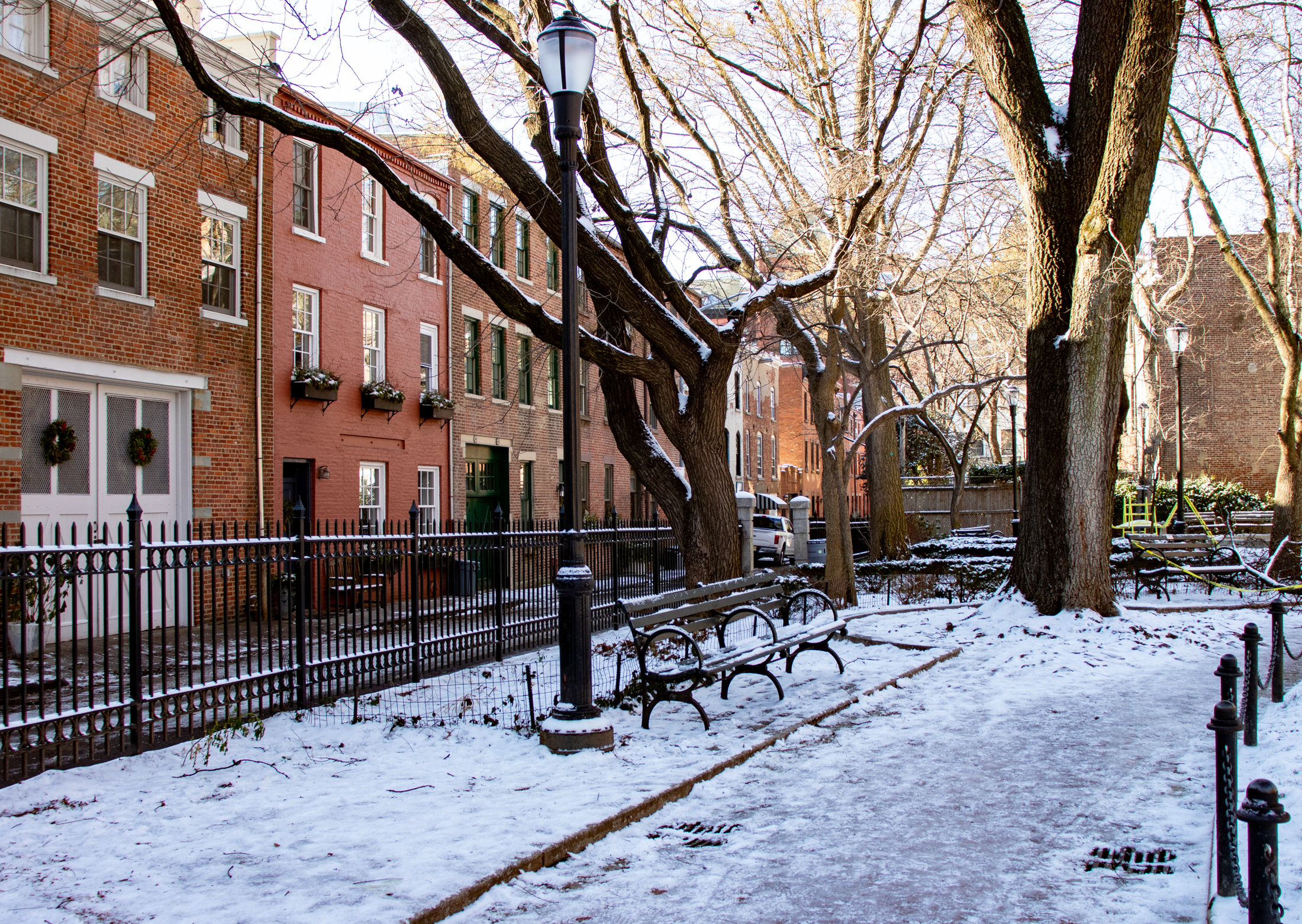 brooklyn - snow in cobble hill park with the carriage houses of verandah place in the background