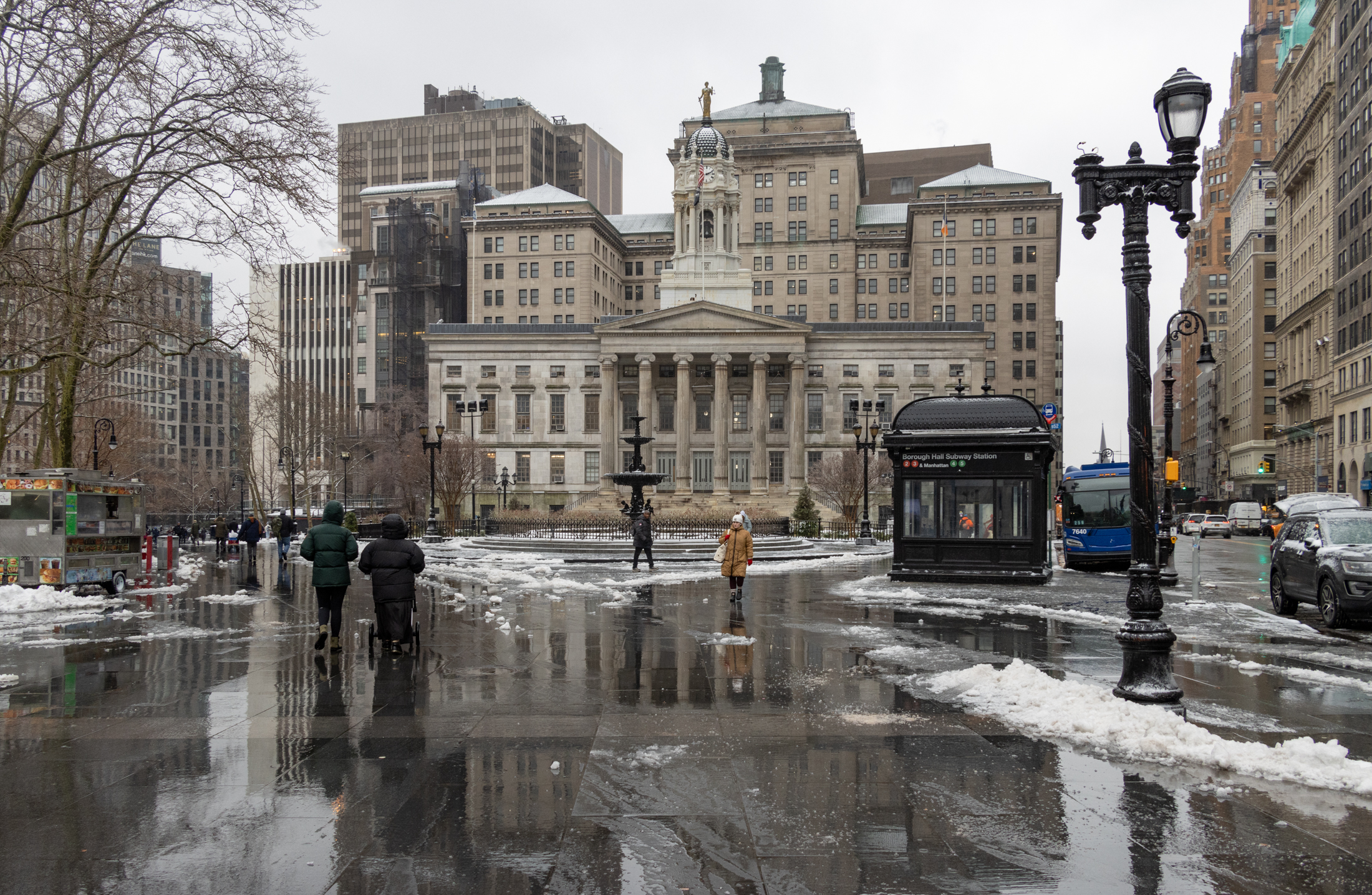 brooklyn - people walk through snow near borough hall