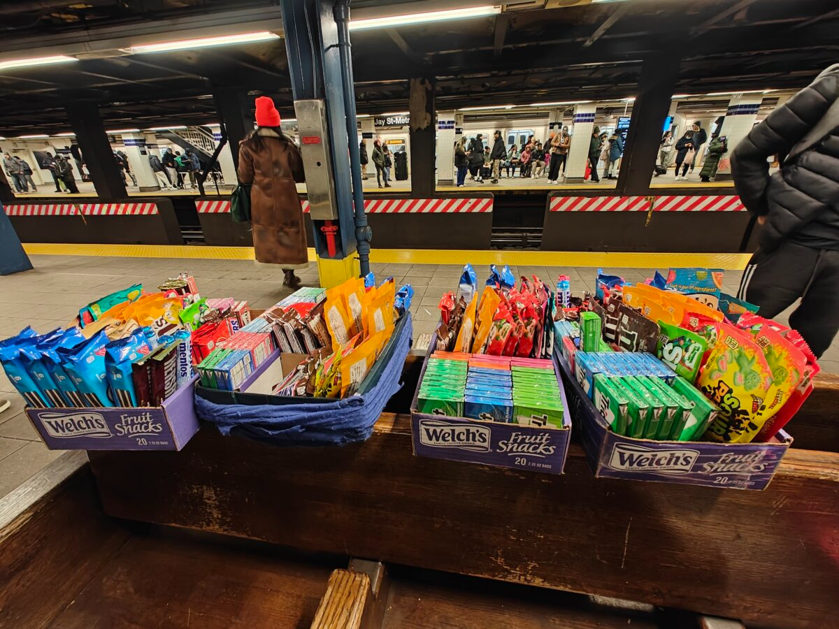 migrant vendors - boxes of candy carried by vendors in the subway