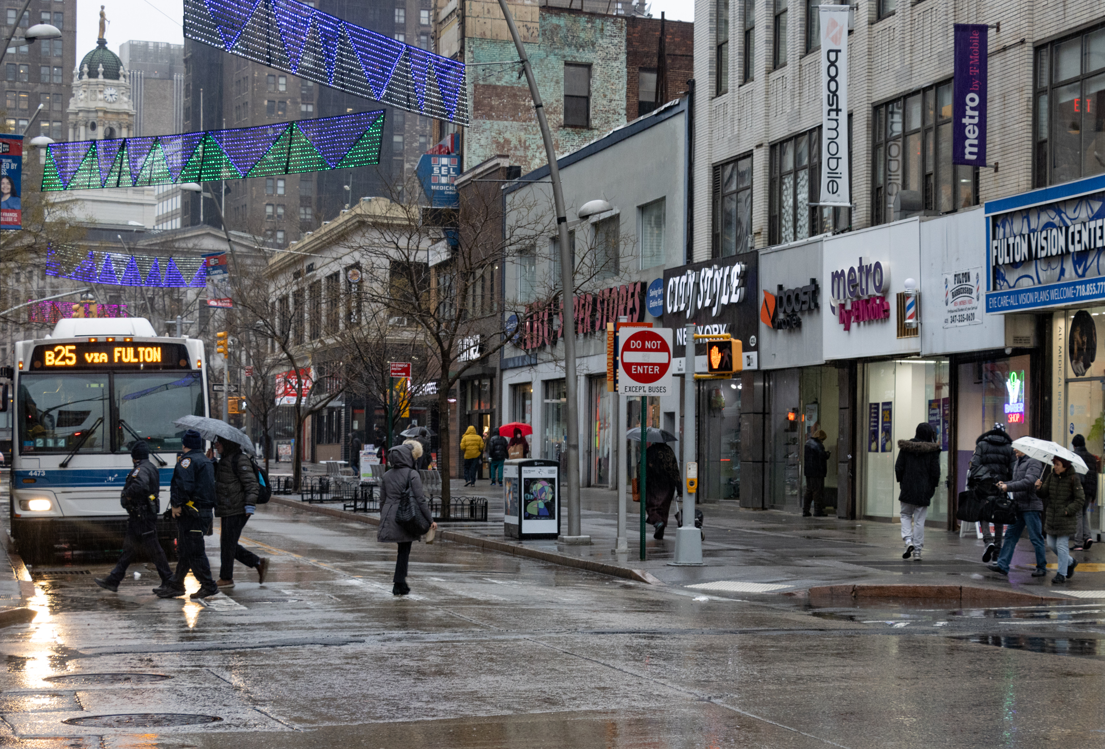 brooklyn - pedestrians in the rain on fulton street in downtown brooklyn