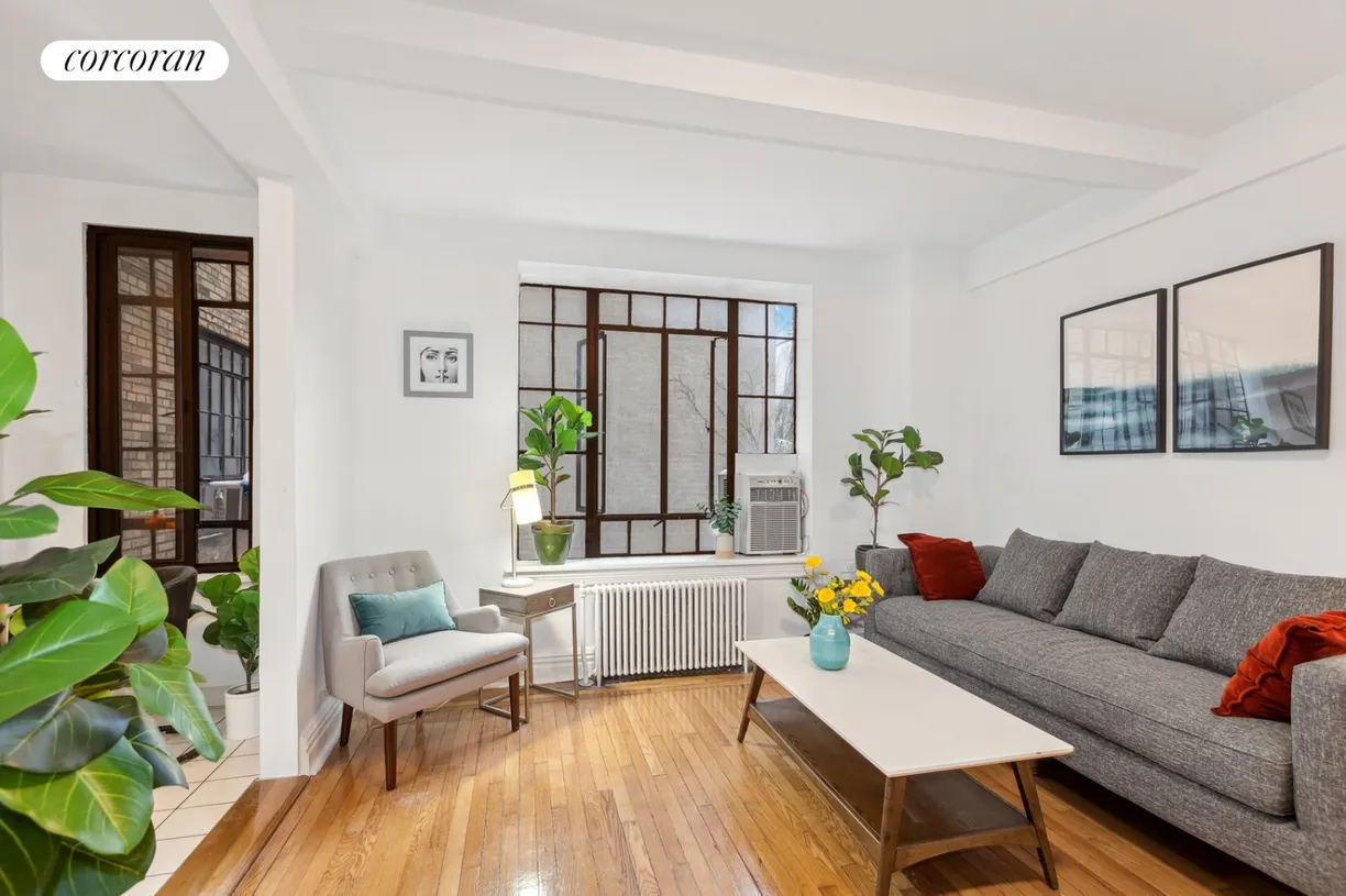 living area with window and view into kitchen