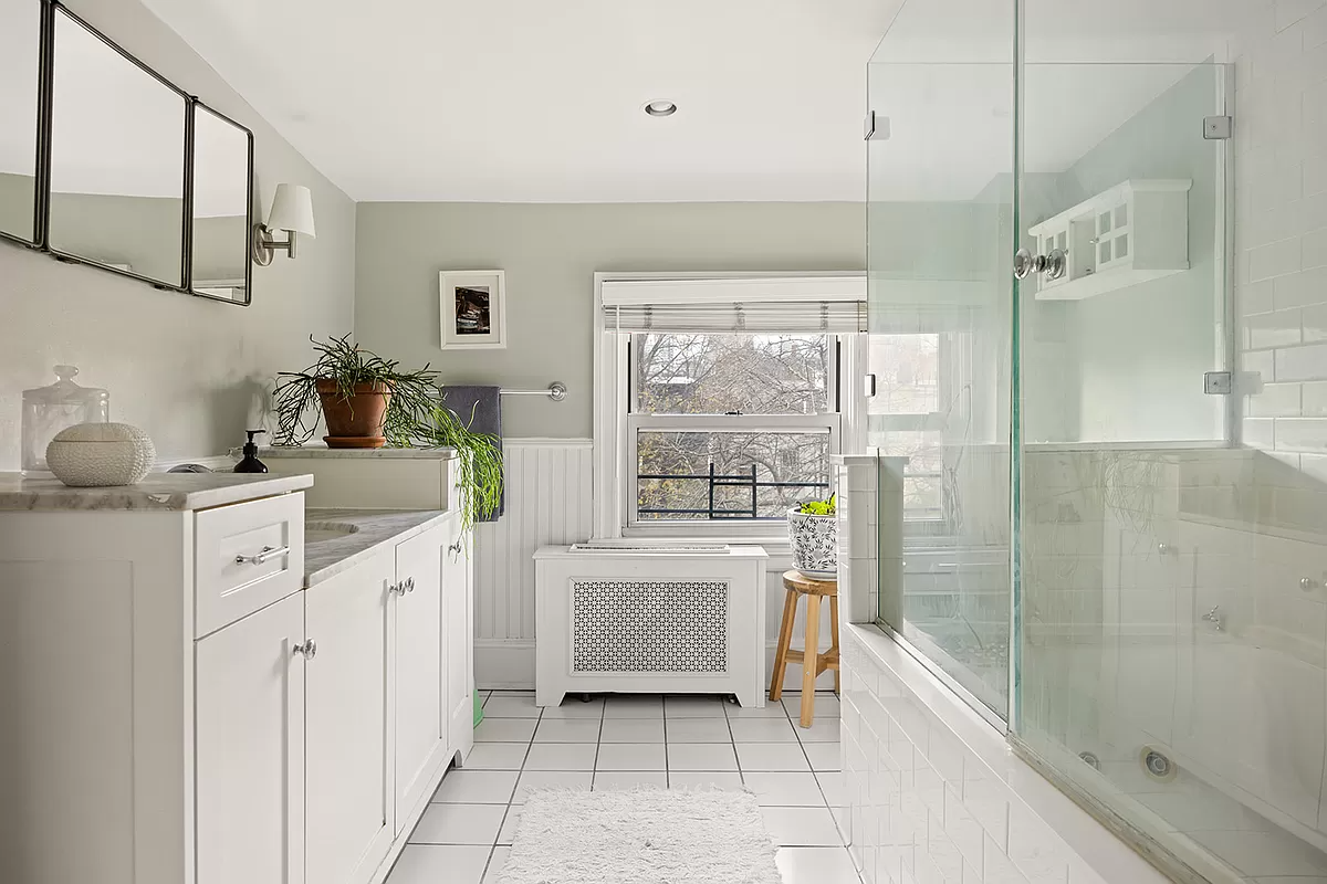 bathroom with white fixtures and tile floor