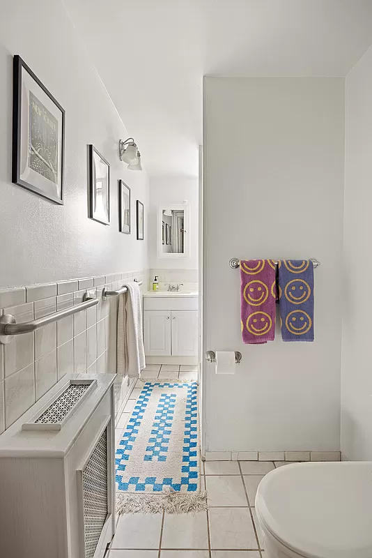 bathroom with white tile and fixtures