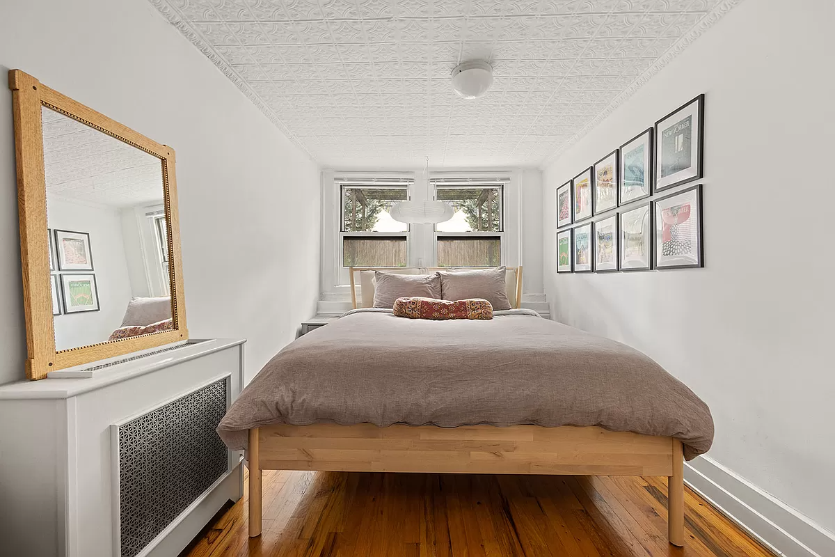 garden level bedroom with tin ceiling