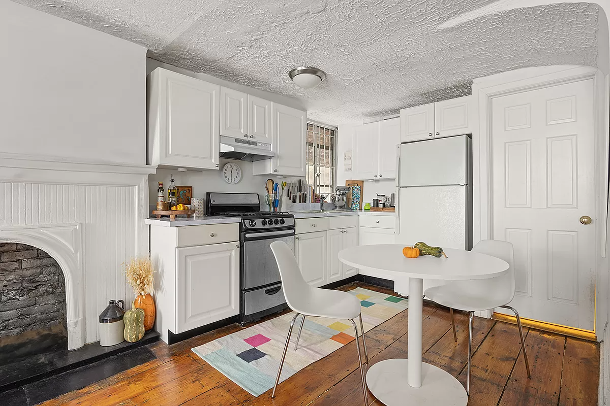 kitchen with white cabinets and a white mantel