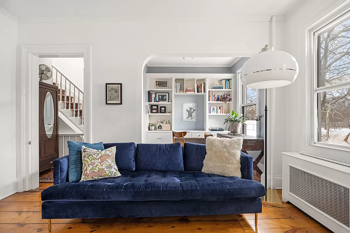 living room with arched opening to office