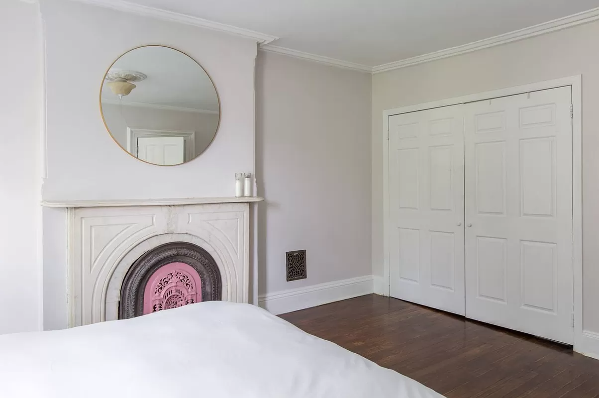 bedroom with a marble mantel