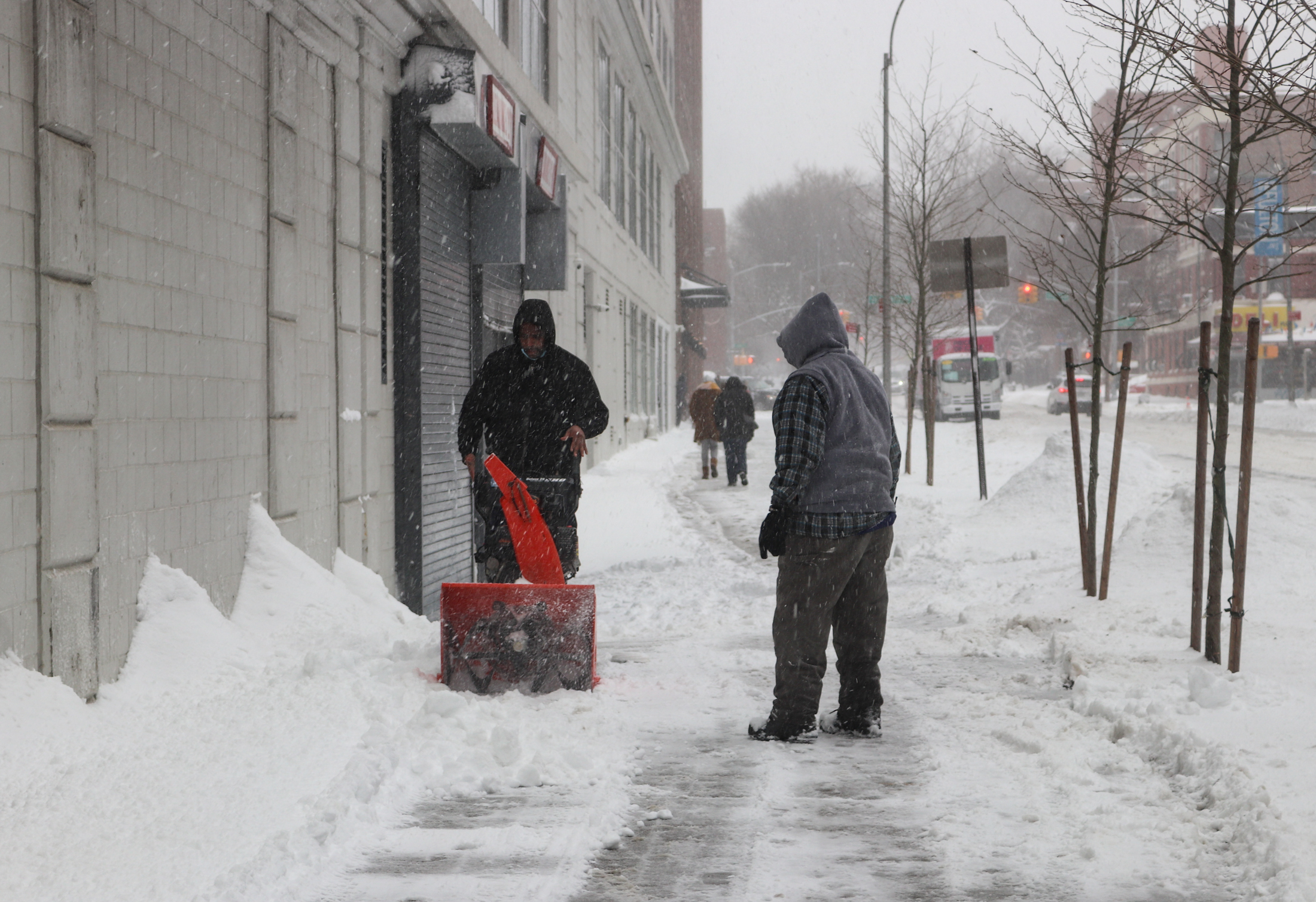 clearing the sidewalks of snow