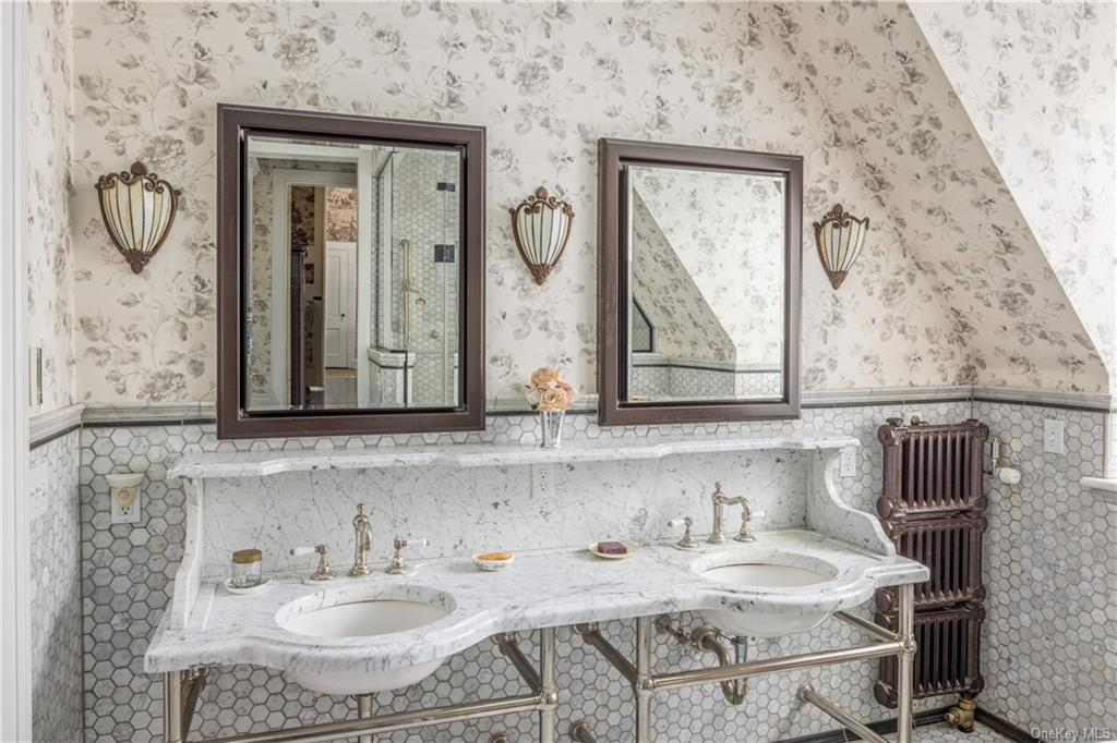 bathroom with double period style vanity with stone counter