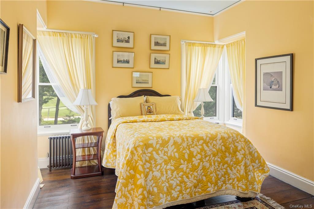 bedroom with yellow walls and two exposures