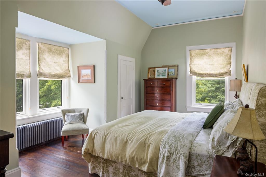 bedroom with sage green walls and two exposures