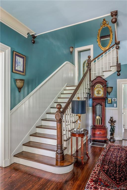 entry with stair with wainscoting