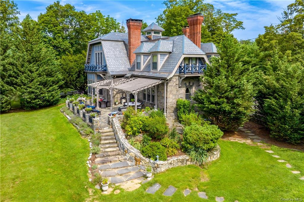 garrison - view of the rear of hte house with stone steps to a patio