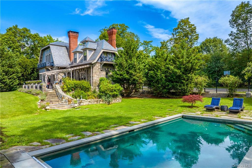 pool with view of the patio at the rear of the house