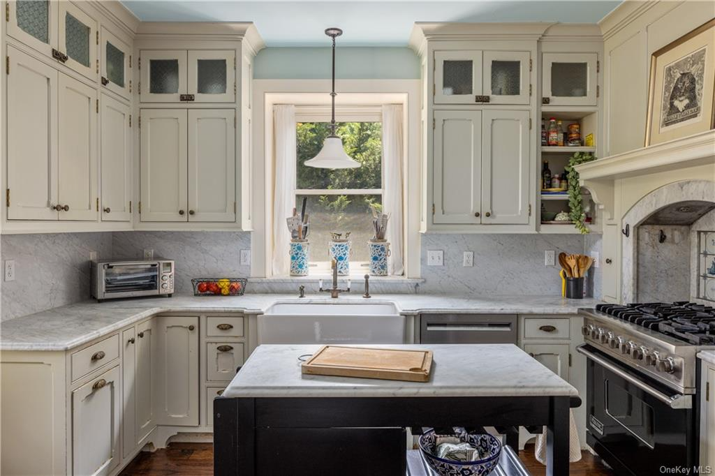 kitchen with cream cabinets and marble counters