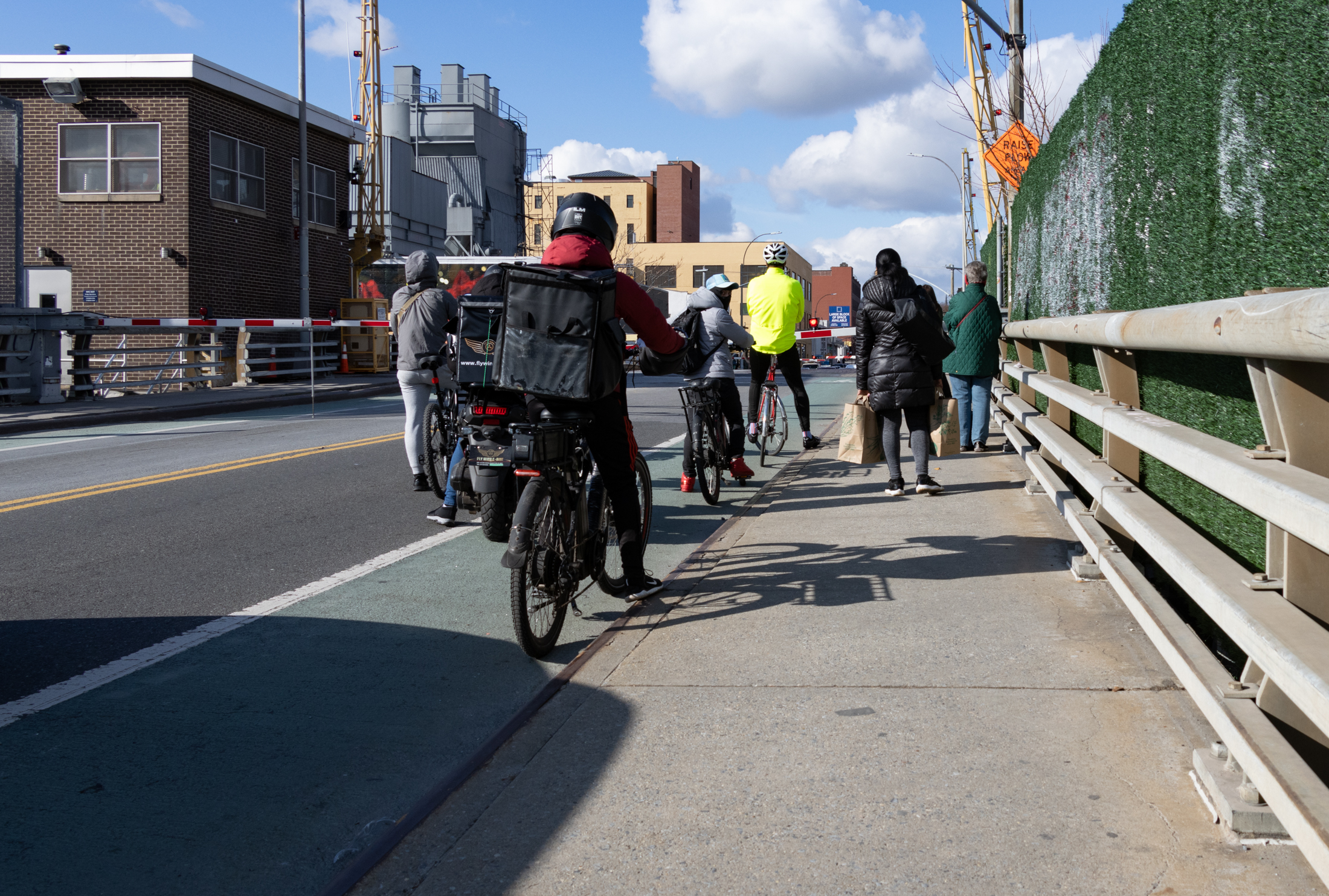 gowanus - bikers and pedestrians waiting to cross the 3rd street bridge