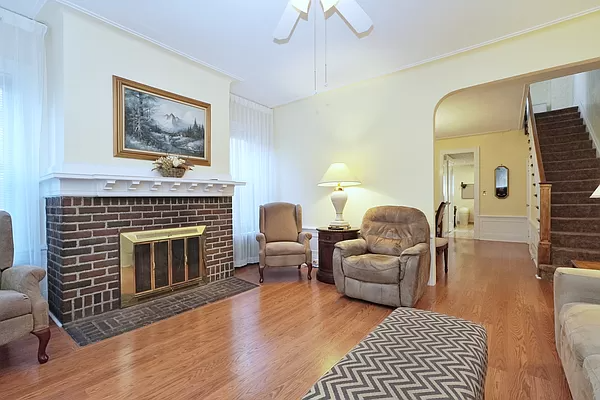 living room with a brick fireplace