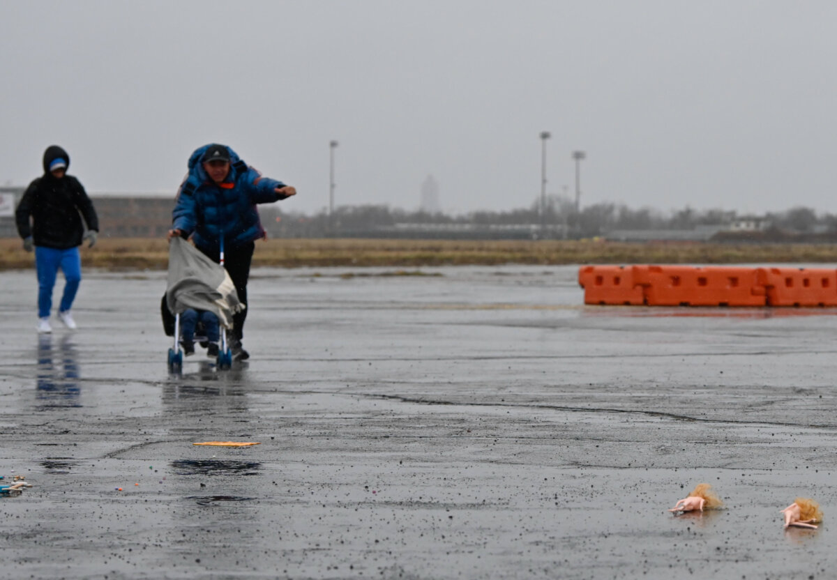 migrant shelter - people in the rain at floyd bennett field