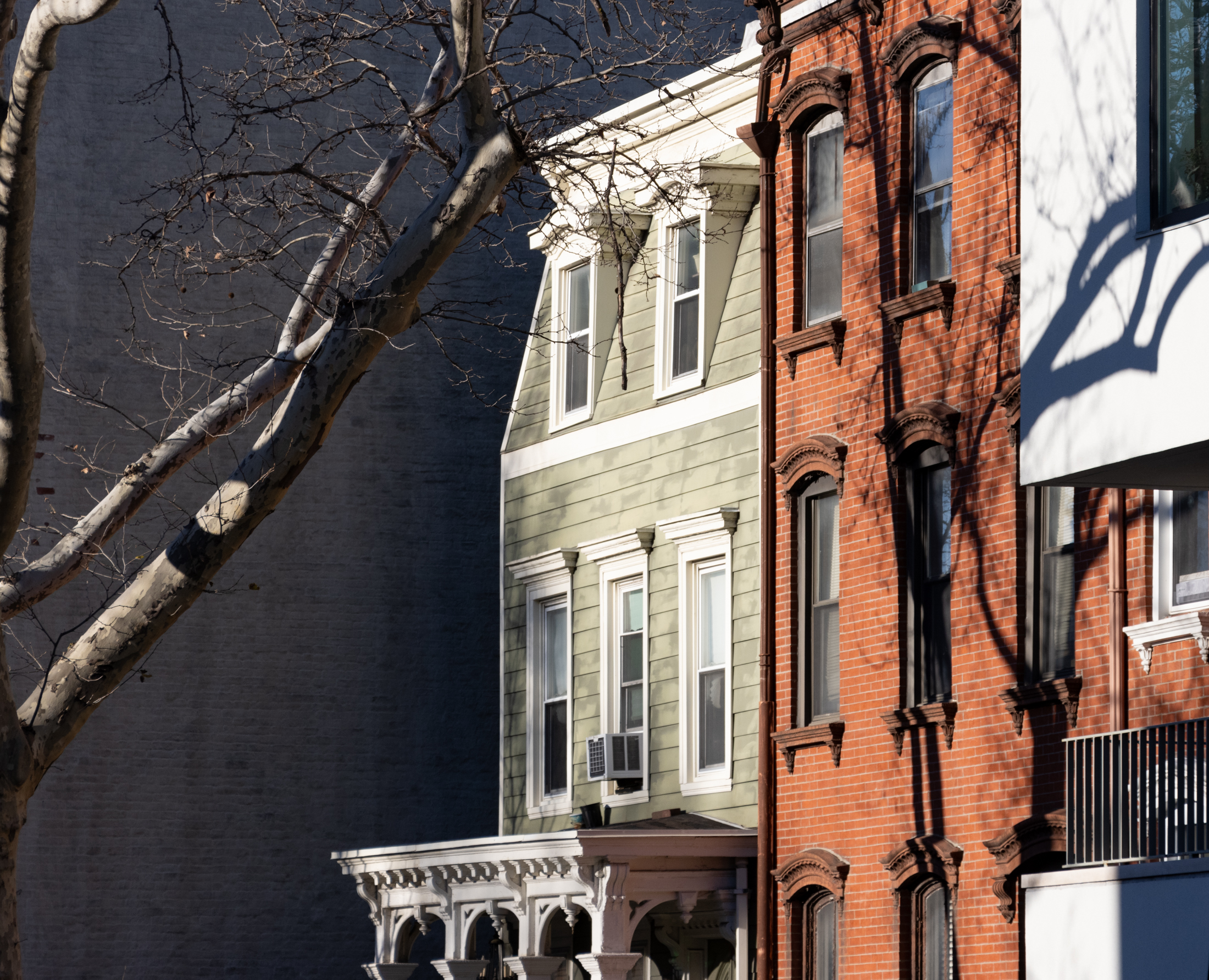 brooklyn - a brick house and a wood frame house