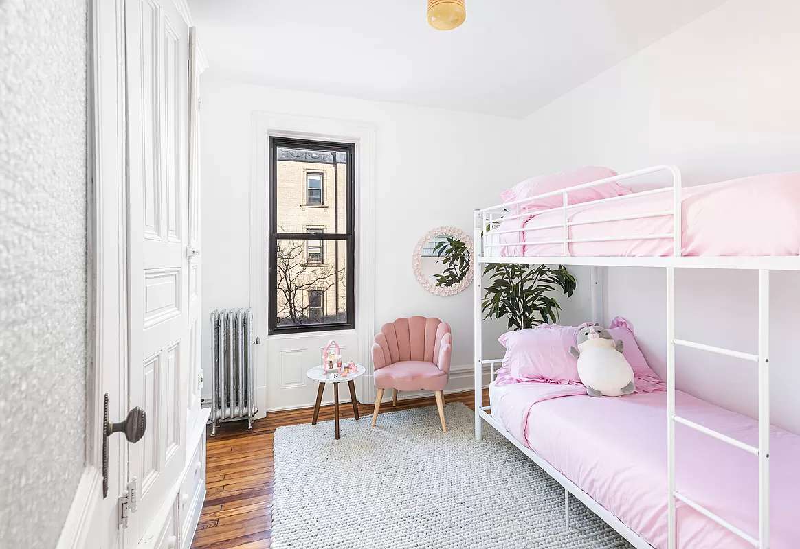 bedroom with white walls and one window