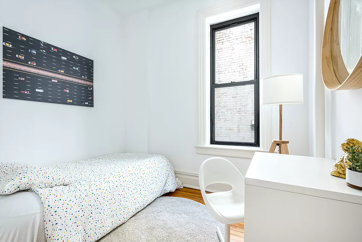 bedroom with one window with view of brick wall